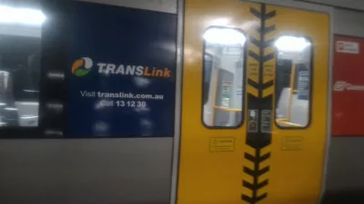 How to go with the Airtrain Brisbane from airport to city center? : Train arriving in station at airport