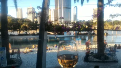 What are the best bars in Brisbane? : Glass of wine with view on Brisbane skyline at SouthBankBeerGarden