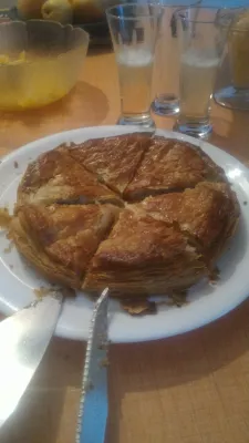 Galette des rois history of frangipane delight : Frangipane galette des rois cut in slices and served with champagne