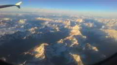 Tourism carbon footprint higher than expected, here’s how to travel more responsibly : Alps moutains seen from plane