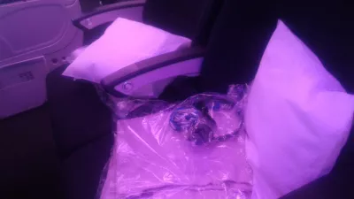 Air New Zealand planes inside flight review : Pillow, blanket and headset waiting on the seat