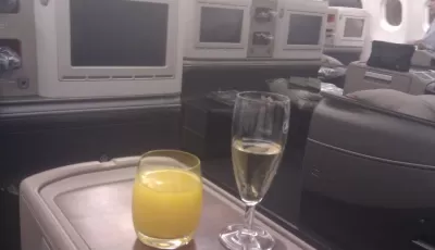 Business Class Tricks: How Can I Fly More For Less? : Drinking champagne in a business class seat with Turkish airlines