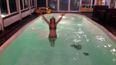 Kiev beach club and Kiev nightlife in summer : Ukrainian girl in bikini enjoying indoor pool in boutique hotel spa