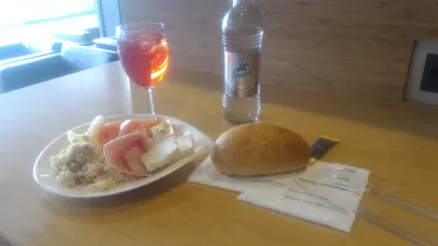 How is the Luxembourg airport business lounge? : Glass of wine and plate with food