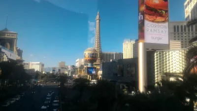 Walking on the best parts of Las Vegas strip up to the neon museum : Paris hotel seen from a sky bridge