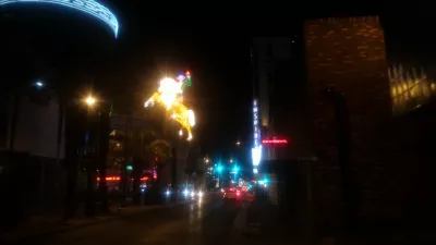 Walking on the best parts of Las Vegas strip up to the neon museum : Vegas vic famous neon cowboy sign at the entrance of Fremont street experience