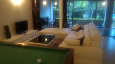 What are the best places to stay in Tahiti? : Living room with billiard pool table inside a flat in Carlton Plage residence