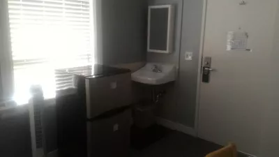 What is the cheapest hotel room in San Fran Union square? : Sink, fridge and heater in The Urban cheap hotel room