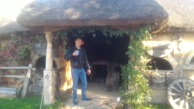 Hobbiton movie set tour, a visit of the hobbit village in New Zealand : Having a complimentary Hobbit beer in front of the forge