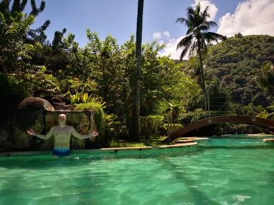 How is the longest swimming pool in Polynesia? : Enjoying a refreshing shower under a water fountain at Carlton Plage residence