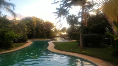 How is the longest swimming pool in Polynesia? : Swimming pool, tahiti lagoon, and pacific ocean under the setting sun