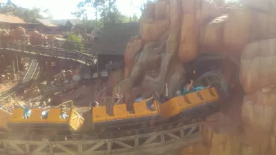 How is a one day visit at Disney's Magic Kingdom? : Big Thunder Mountain Railroad train entering a mountain