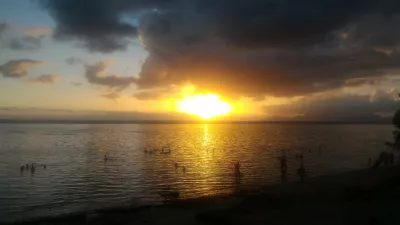 Beautiful sunset images on Tahiti best beach : Yellow sunset in Tahiti over Moorea island free images download