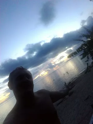 Beautiful sunset images on Tahiti best beach : Grey, yellow and orange sunset in Tahiti over Moorea island selfie