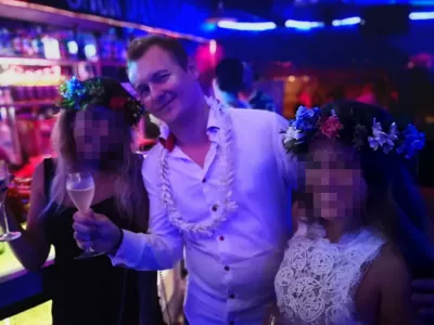 What is the Tahitian flower tradition? : Man wearing flower necklace and girls wearing floral crowns at a party in Papeete, Tahiti, French Polynesia