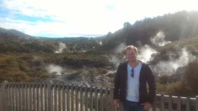 A visit of Wai-O-Tapu thermal wonderland and Lady Knox geyser : With steam coming out of the ground in the background