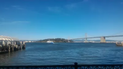 Walking on Embarcadero center in San Francisco : View on San Francisco - Oakland Bay bridge from Ferry building terrace